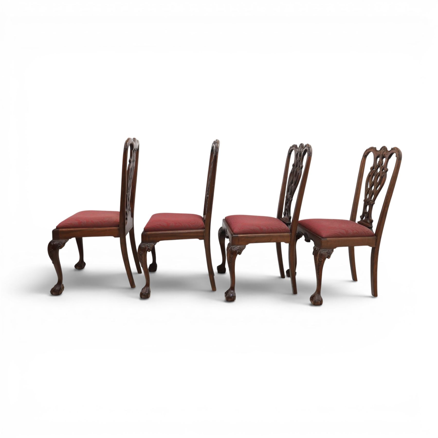 Chippendale design set of ten (8+2) mahogany dining chairs, serpentine cresting rails with carved detail over pierced ribbon-tied splats, red damask upholstered drop-in seats, on cabriole supports with acanthus carved knees and claw and ball feet