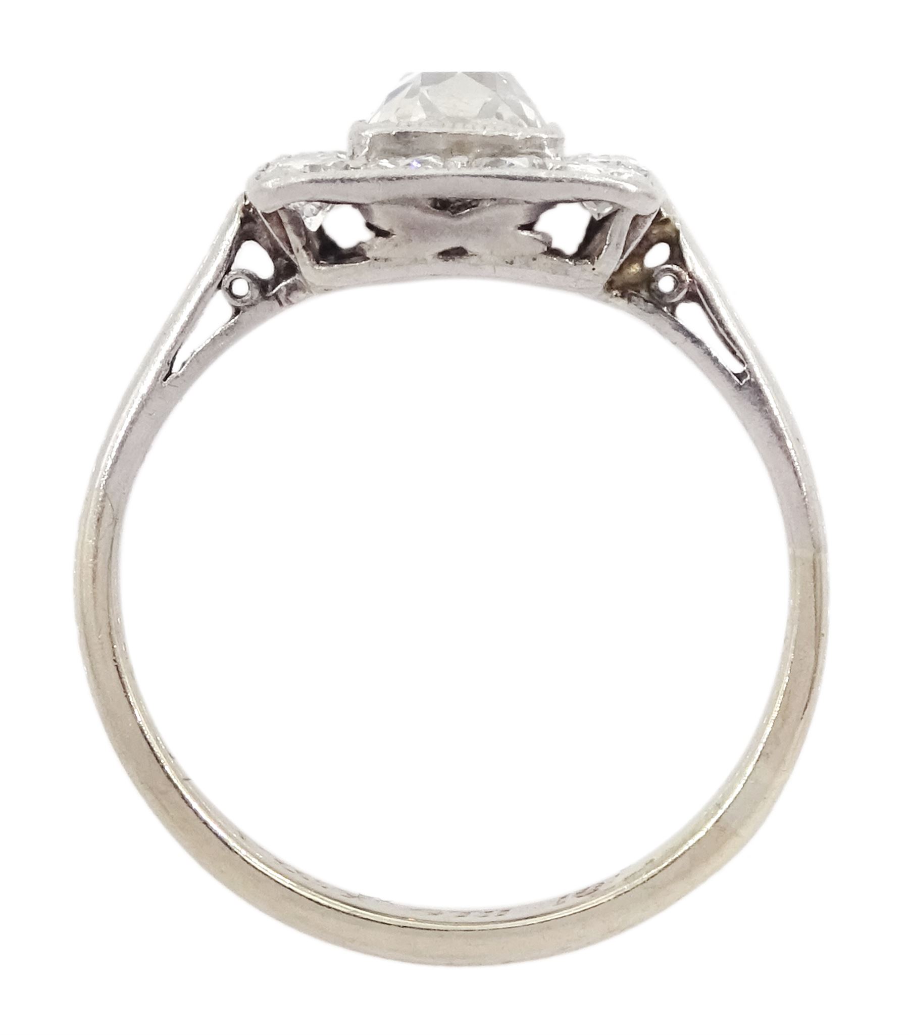 Art Deco platinum and white gold milgrain set diamond ring, circa 1920's, the central cushion cut diamond of approx 0.90 carat, with old cut diamond surround, total diamond weight approx 1.10 carat