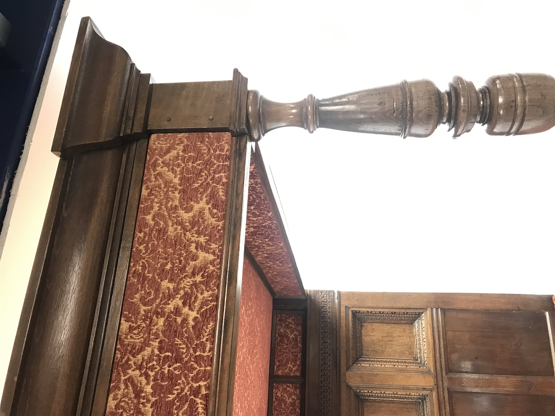 17th century and later Jacobean style oak four poster bed with canopy, the projecting canted cornice above patterned fabric frieze supported by two turned posts, the back with geometric guillouche carved frieze and three deeply recessed panels with egg and dart and other decorative mouldings, W155cm, H217cm, L220cm