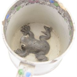19th century frog and newt cup, decorated with a house in a landscape and cows, featuring a frog and newt inside the cup, together with three other frog cups 