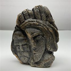 Double sided stone carving, depicting faces, signed Venezuelan to the base, H16cm
