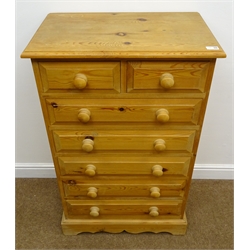  Solid pine chest of two short and five long drawers, turned wooden handles and shaped plinth, W66cm, H107cm, D42cm  
