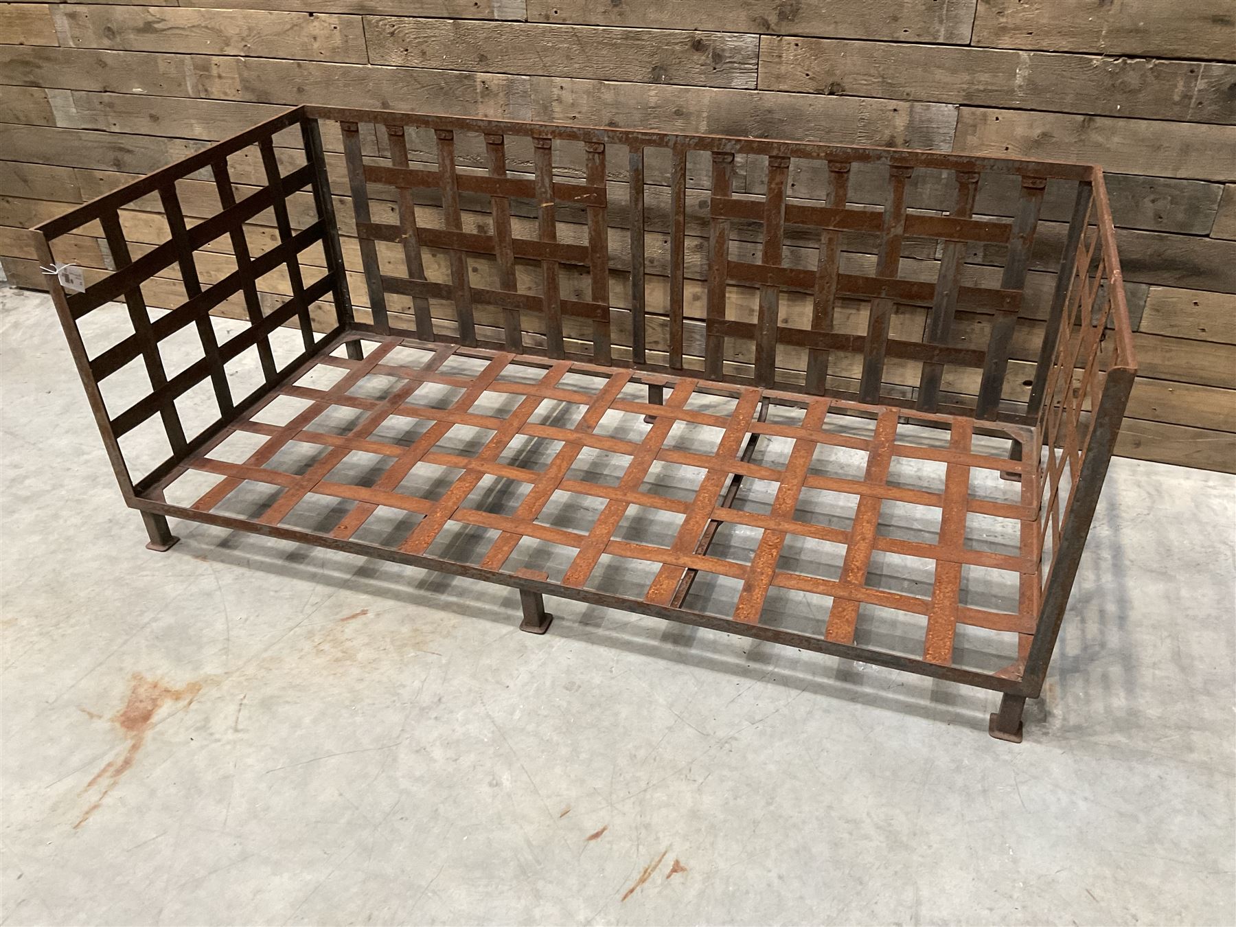 Wrought iron strapwork garden day bed, lattice back and sides