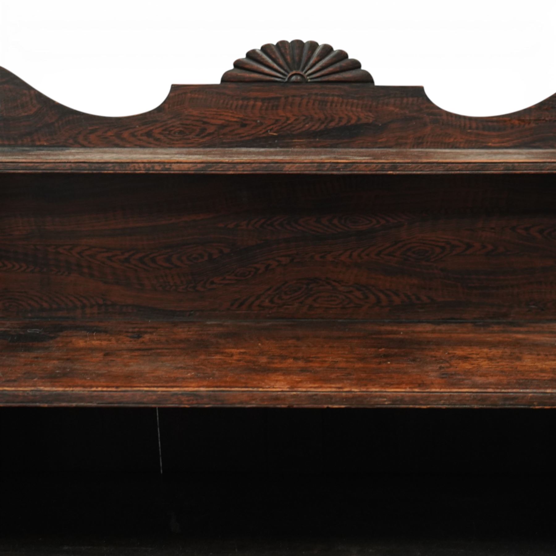 Regency simulated rosewood chiffonier, with shaped scroll supports and shell carved cresting, over a pair of panelled doors inset with diamond lattice glazing, enclosing a shelved interior, raised on short turned feet