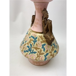 A late 19th century Aesthetic Movement Old Hall vase designed by Christopher Dresser, the flared body decorated with stylised flowering vines, leading to a tapering neck and flared rim with twin figural handles (one s/d), and raised upon a circular footed base, with printed mark beneath, H35cm. 