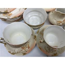Early 20th century Limoges part tea service, decorated with floral sprays and gilt on merging peach and white ground, comprising six teacups, twelve side plates, six smaller plates, milk jug, open sucrier, slop bowl and two cake plates, many marked R Delinieres Limoges D&C France to base