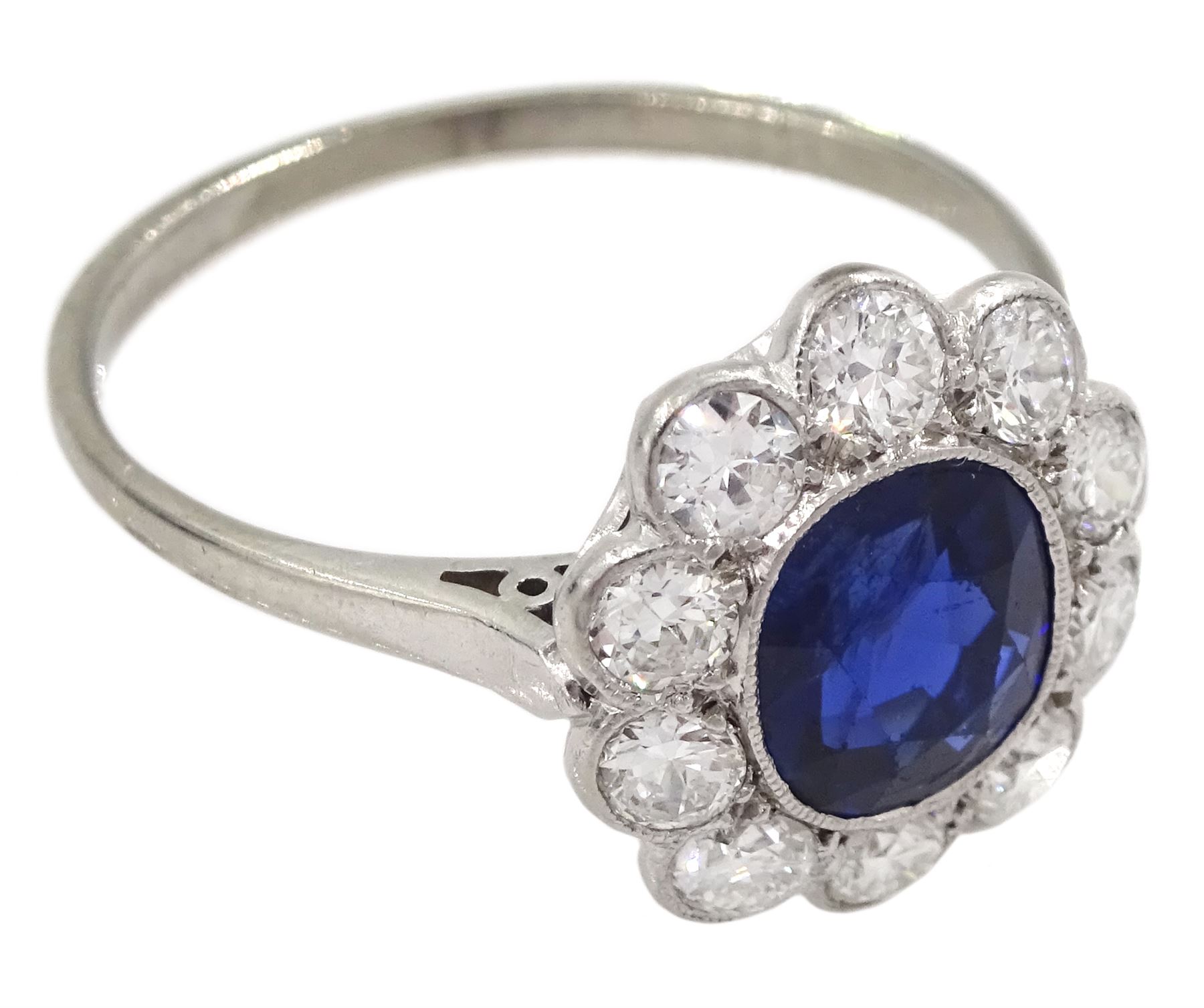 Palladium and platinum milgrain set oval sapphire and diamond cluster ring, sapphire approx 1.35 carat, total diamond weight approx 0.55 carat