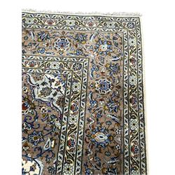 Persian Kashan ivory ground carpet, central medallion on a field of scrolling foliate branches decorated with palmettes, the border decorated with repeating stylised plant motifs, floral design guard stripes