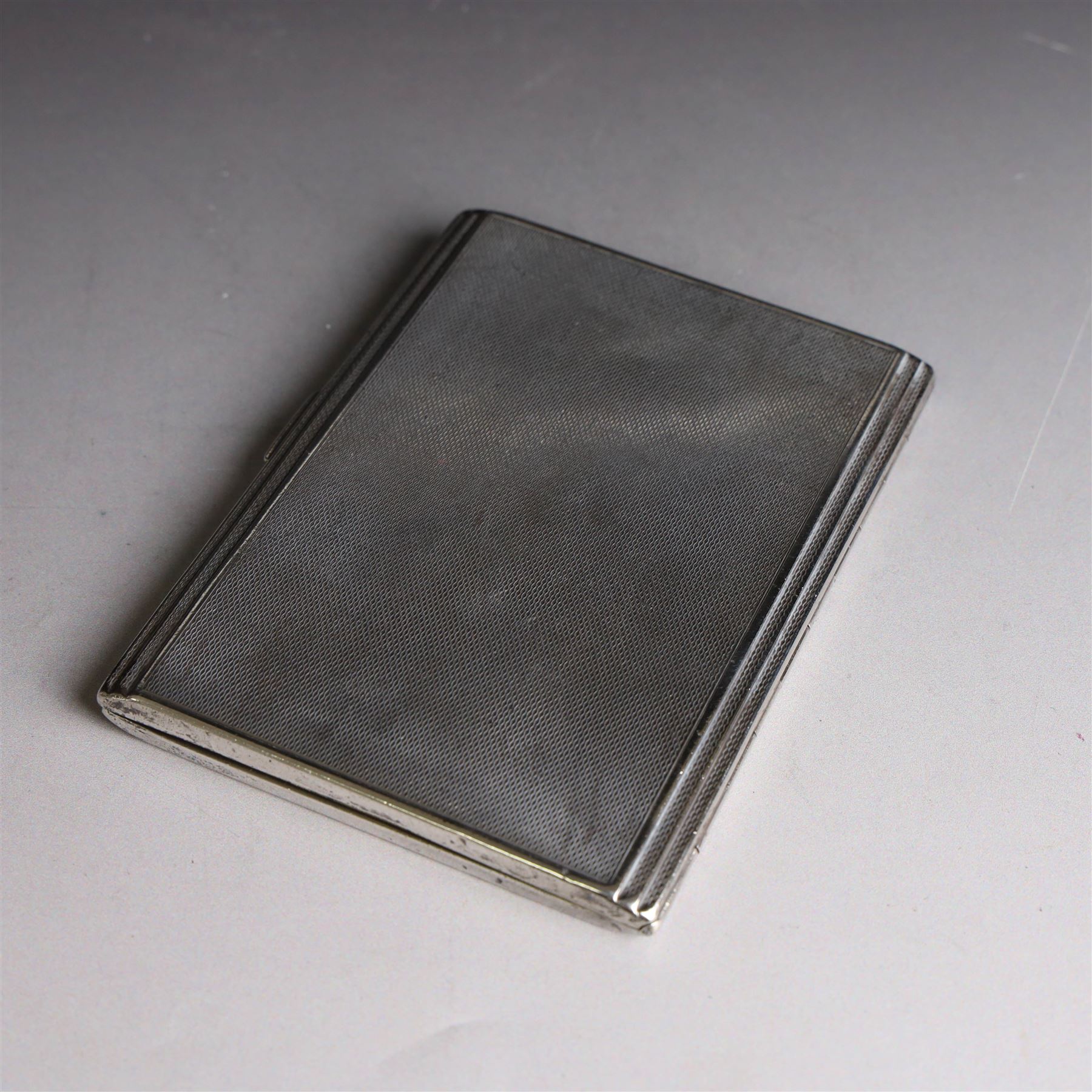 1930s silver cigarette case, with stepped design and engine turned decoration, hallmarked Clark & Sewell, Chester 1938, H11cm