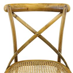 Set of four Oka style rattan dining chairs, bentwood frames inset rattan seat