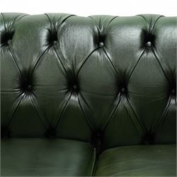 Late 20th century chesterfield style sofa upholstered in green leather, with deep buttoned back and arms above three loose cushions, continuous scroll arms and front, on concealed block feet