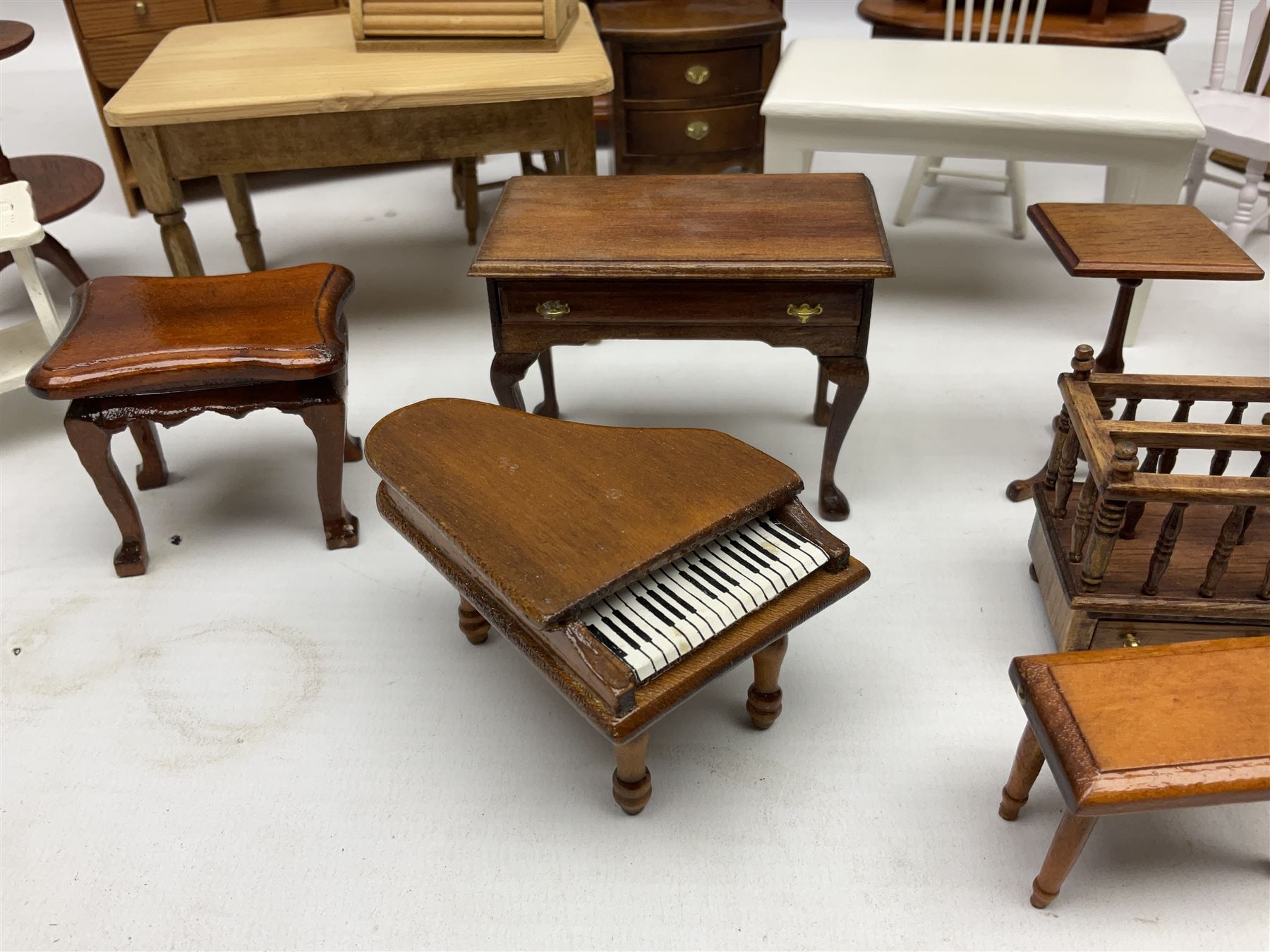 Doll's house wooden furniture - over twenty items including good quality pine Welsh dresser by Tony of Lincoln; tall 'glazed' bookcase; two-tier side cabinet; grand piano; bedside chest, mule chest, Canterbury; cradle; Georgian style hanging corner cupboard; dumb waiter; tables; chairs; rocking chair etc; various scales