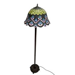 Tiffany style standard lamp, peacock feather lead and coloured glass shade, reeded stem on circular base cast with flower heads and scrolls