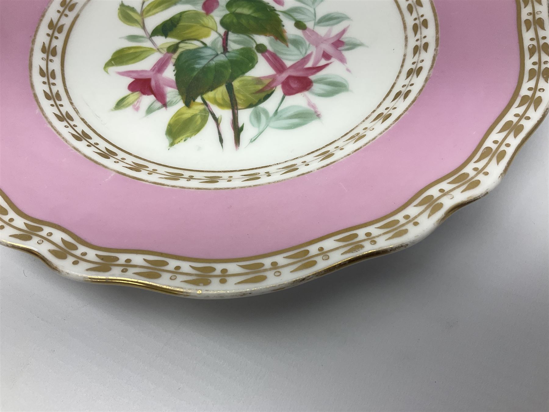 Victorian Copeland, Botanical dessert service, decorated with floral sprigs to the centre with a pink and gilt border, comprising five comports and seven plates, largest comport H20cm, plate D22cm