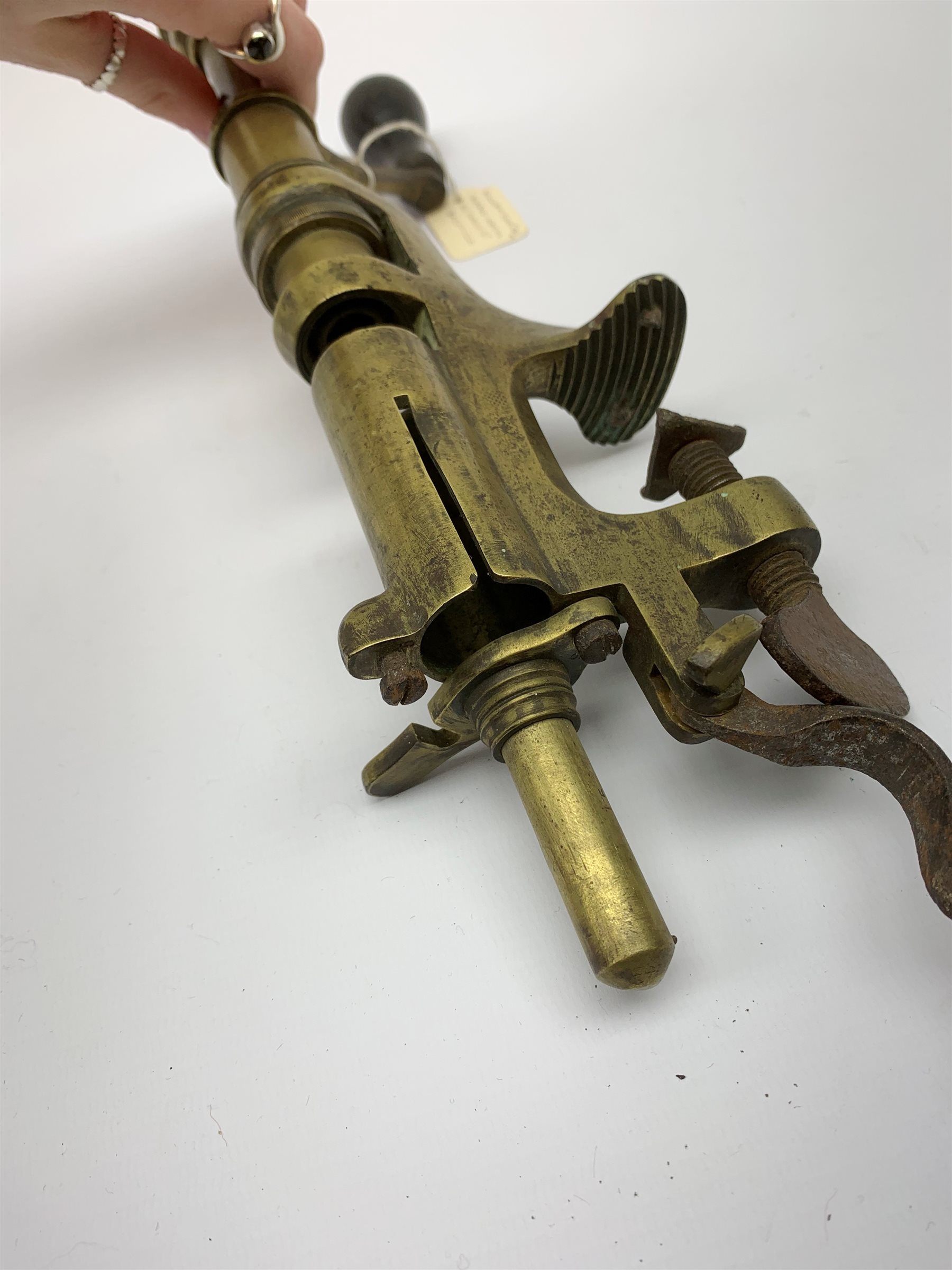 Two 19th century brass 12-bore cartridge making tools comprising bench mounting Bartram & Co Patent 'Nimrod' re-loader and J.C. Cocker Patent 5535 redecapper with turned wooden rammer (2)