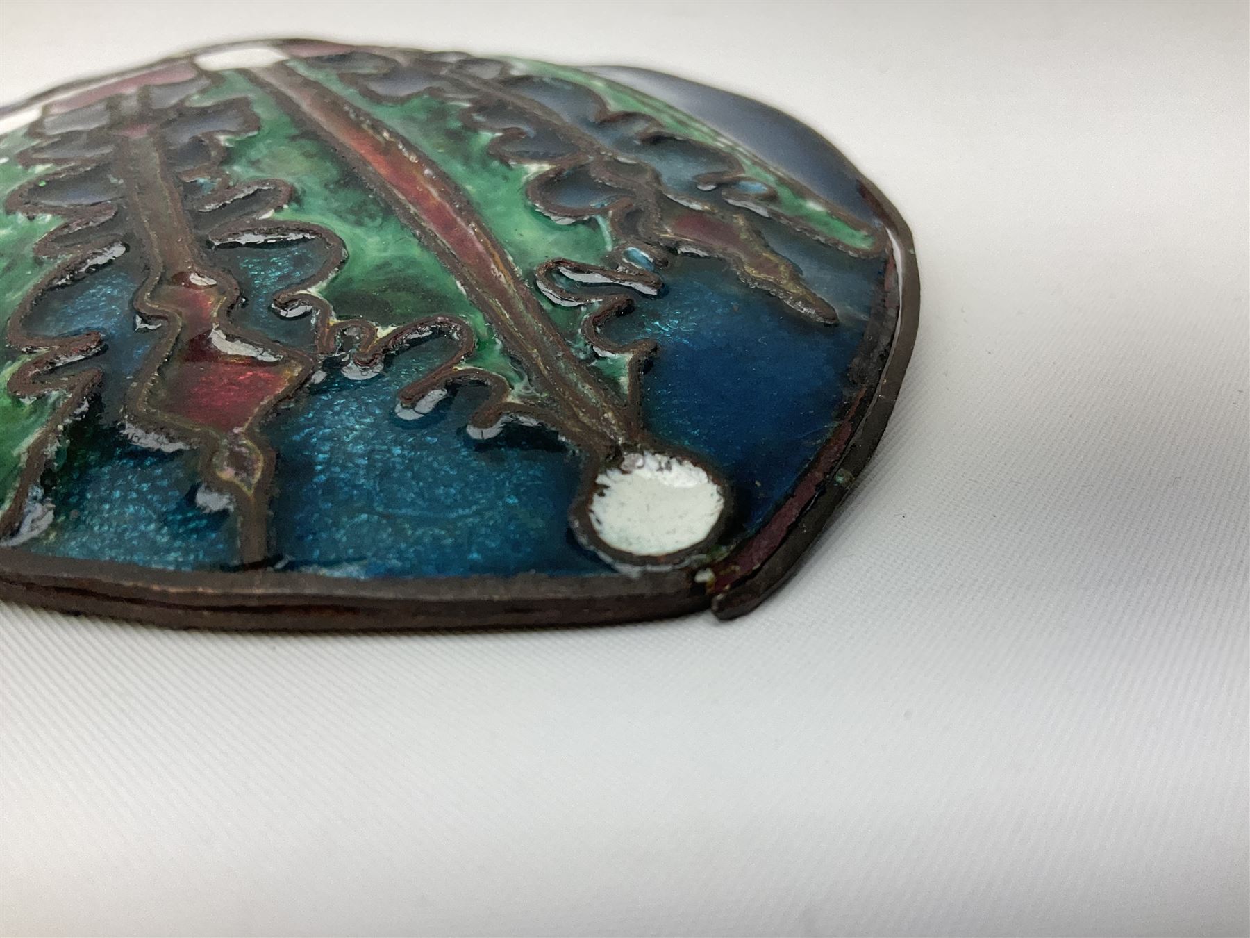 Henry George Murphy (1884-1939), Arts & Crafts enamel panel, of bulbous elliptical form decorated with a stylised crown in green, red and white, upon a turquoise toned ground, H12cm W9cm
