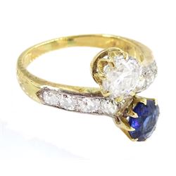 Early 20th century two stone old cut diamond and sapphire crossover ring, with channel set diamond shoulders, principal diamond approx 0.75 carat, sapphire approx 0.70 carat, in velvet and silk lined Collingwood & Son Ltd box