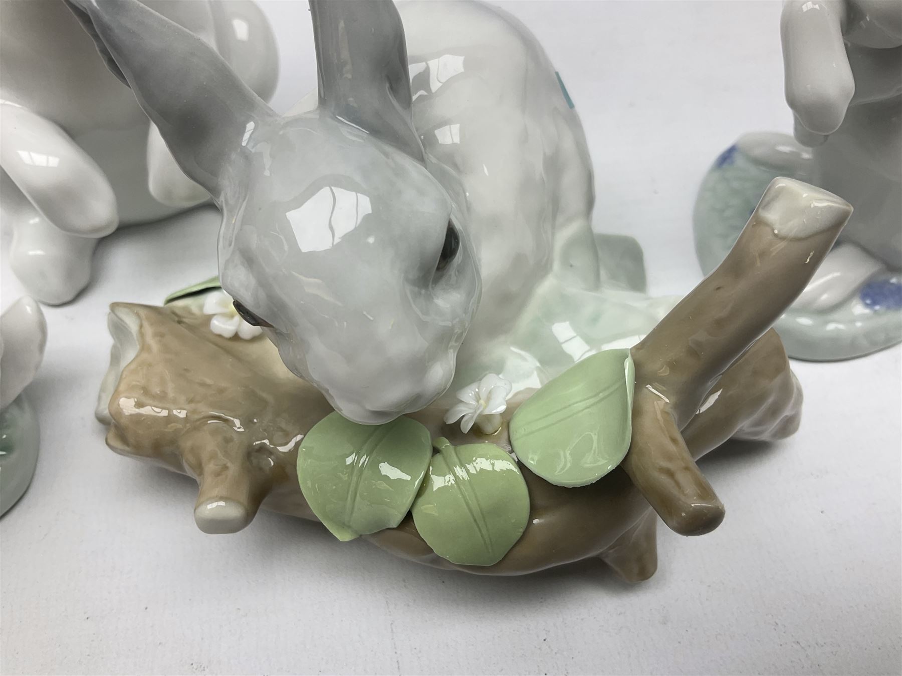 Four Lladro rabbit figures, comprising, Hippity Hop no 5886, Sitting Bunny no 5907, Washing up no 5887, and Rabbit Eating no 4773, largest example 14cm  