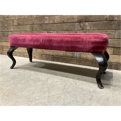 Large rectangular footstool upholstered in a maroon fabric with cabriole supports