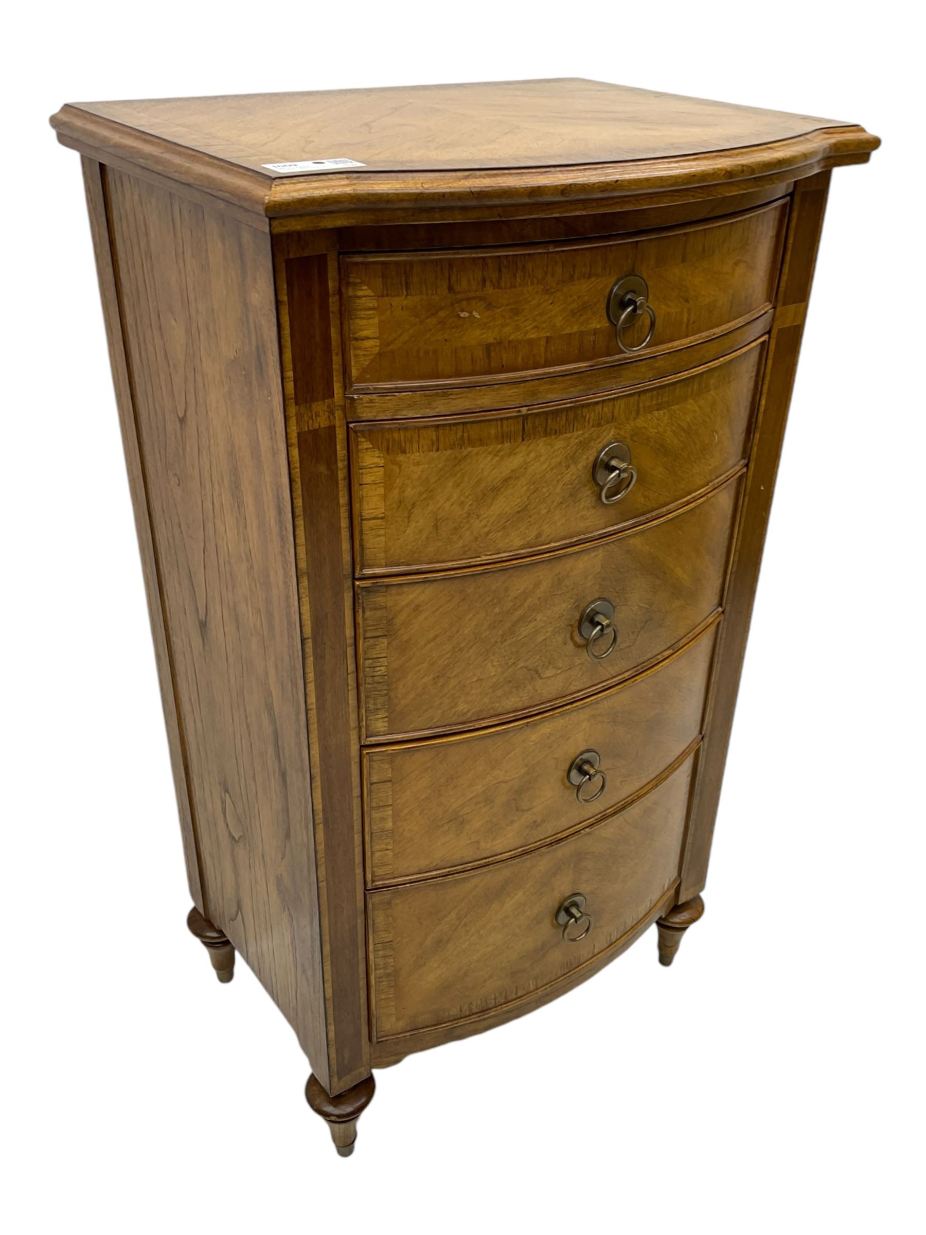 Frank Hudson - mid-20th century Mindi ash and burr walnut bow-fronted lingerie chest, crossbanded hinged top concealing vanity mirror, over five graduated cockbeaded drawers, raised on turned supports