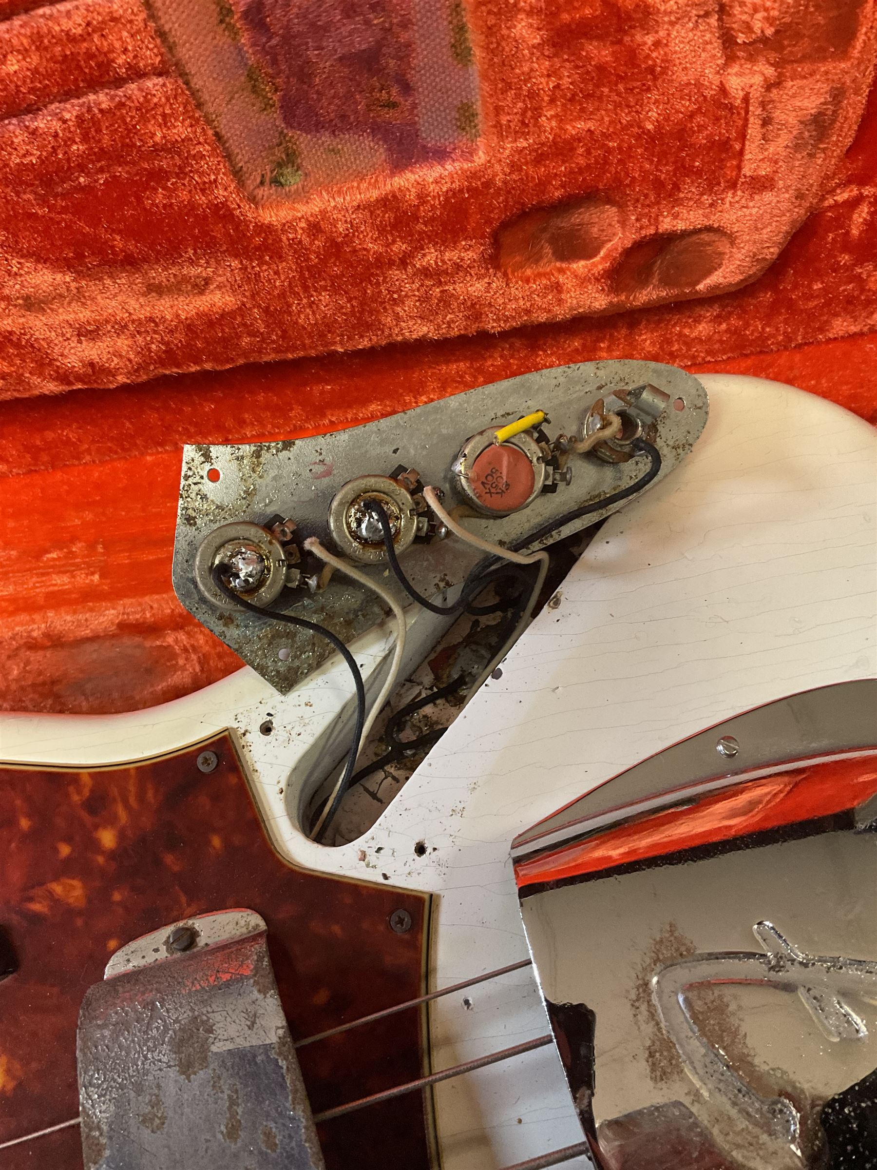 1963 Fender Jazz three-knob bass guitar; impressed with date code 7AUG63A on end of neck and serial no.L08587 on back plate; all original but re-finished in white in the 1970s; sold with photographs of the instrument in the 1960s with original finish and in the 1970s re-finished; L117.5cm; in original hard carrying case; Provenance: the professional guitar of Howard Livett from new to his death in 2005. Howard played in The Humperdincks, the backing group for Englebert Humperdinck, also played in the backing group for Max Bygraves and in the band Hedgehoppers Anonymous. The guitar is also sold with a manuscript letter of provenance from Howard's wife.