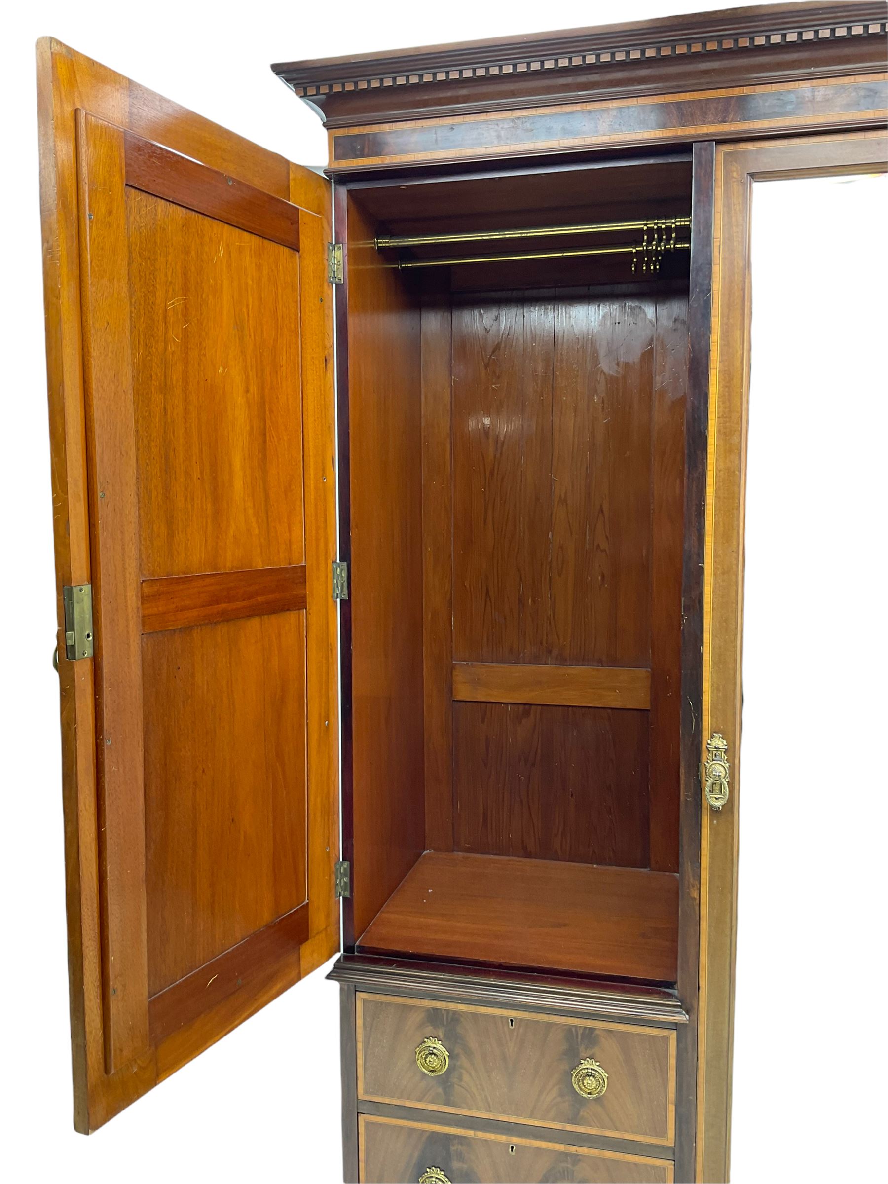 James Shoolbred & Co. London - Edwardian inlaid mahogany triple combination wardrobe, projecting dentil cornice over bevel glazed door, two figured oval panelled doors and four drawers, the central compartment fitted with linen slides and drawers, satinwood banding, on base with shaped apron and bracket feet, with enamel plaque 