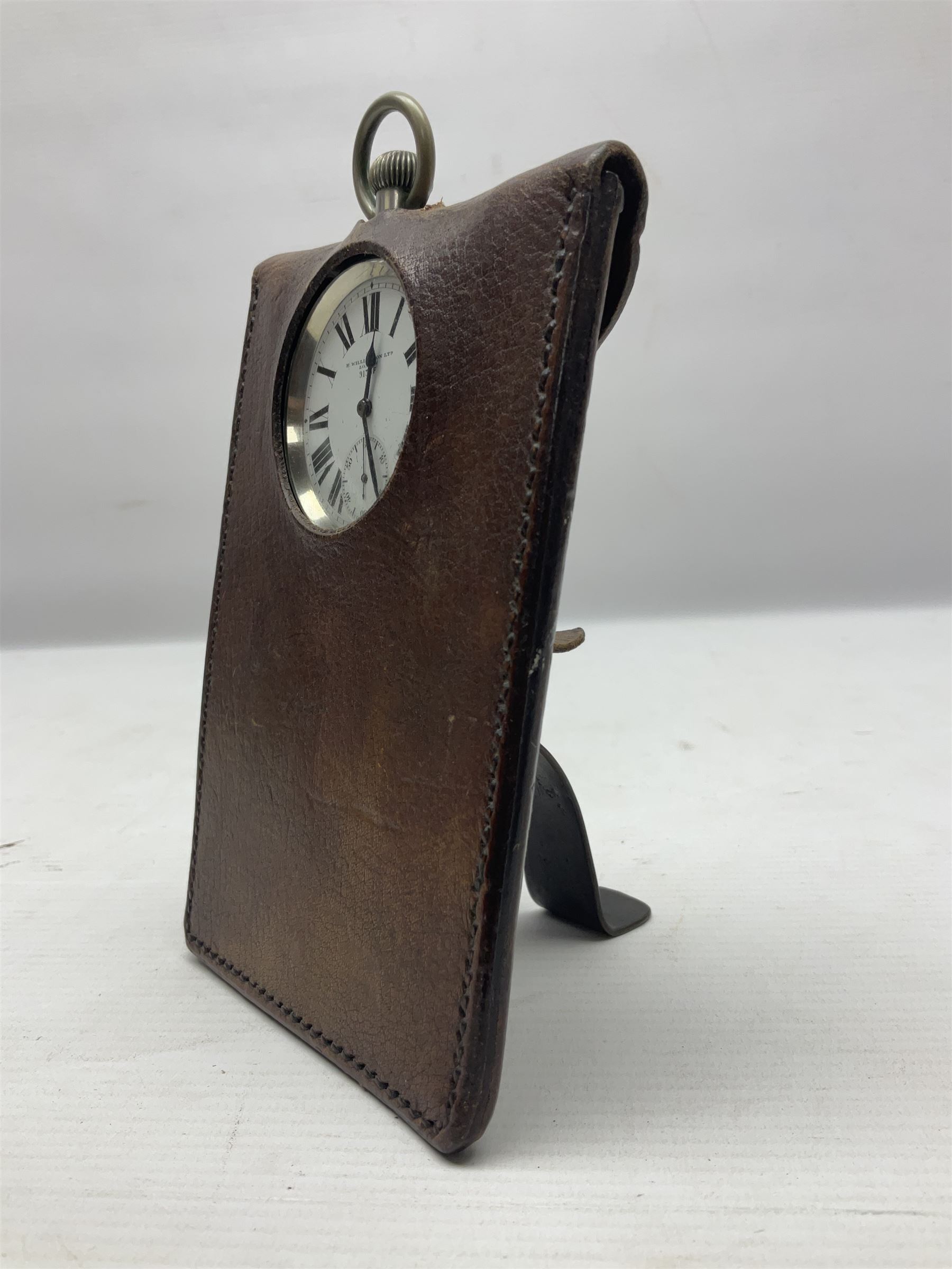 Early 20th century British Army officer's campaign clock in the form of a key-less wind nickel cased pocket watch with white dial, Roman numerals and subsidiary seconds dial, inscribed H. Williamson Ltd. London 9138F, the back with broad arrow and 9138F; in leather travelling case with dial aperture and brass easel support H14cm