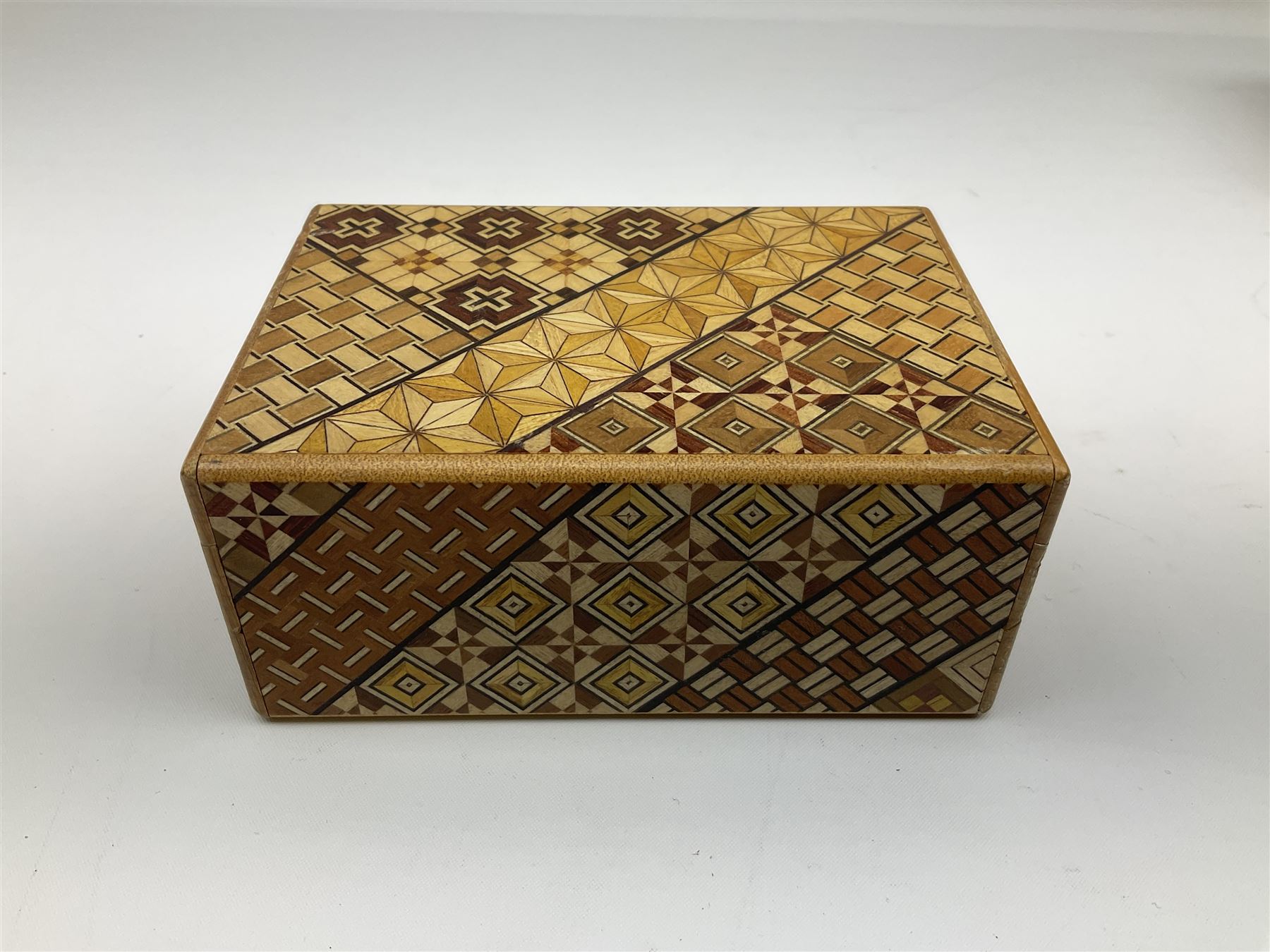 Japanese parquetry puzzle box L12cm; another Japanese puzzle box with marquetry top of Mount Fuji; eleven graduated Chinese figures including immortals; and Chinese figure of a lady standing on a hardwood base next to a horn table (14)