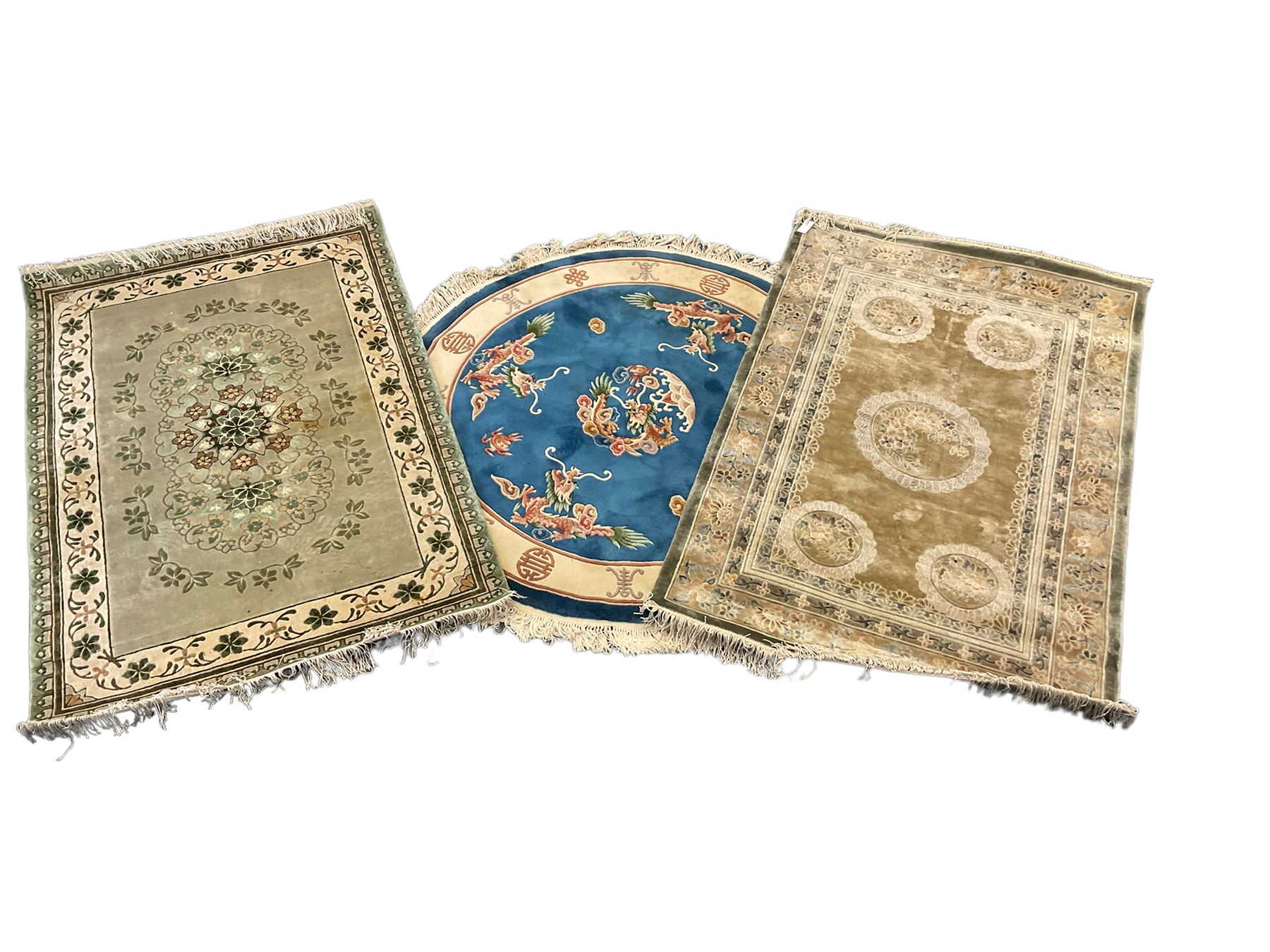 Three Chinese washed woollen rugs - circular blue ground decorated with dragons (D160cm), rectangular light green rug (185cm x 123cm), and a rectangular green rug (185cm x 123cm)