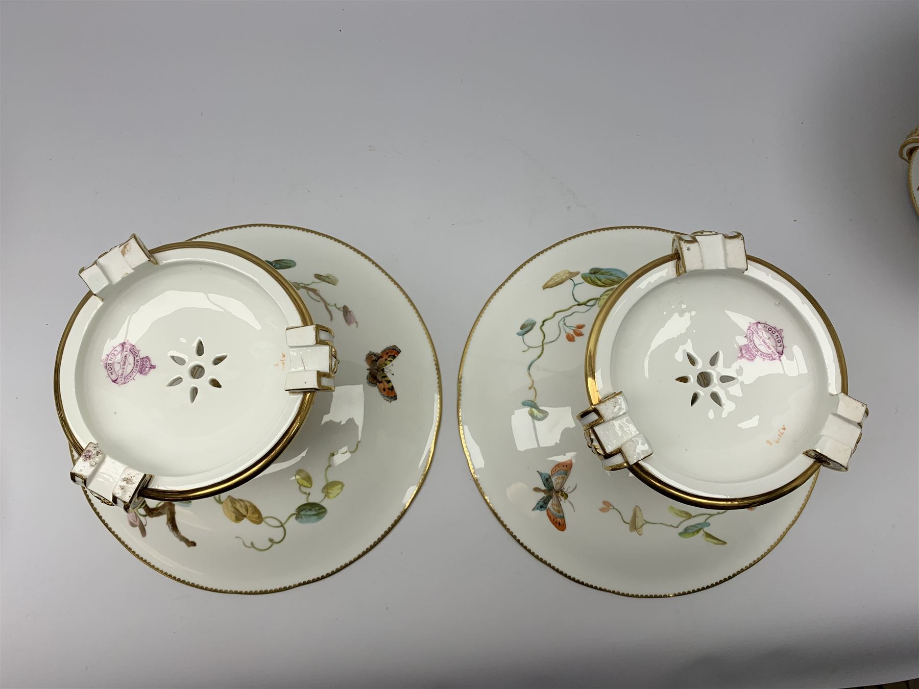 19th century Minton dessert service, comprising four comports, one tazza, and twelve plates, each hand painted with birds perched upon branches, and further detailed with insects and heightened in gilt, with printed retailers mark beneath for John Mortlock Oxford Street London, and impressed Minton mark to most, comport H13.5cm, plates D23.5cm. 
