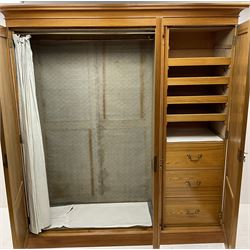 Early 20th century ash triple wardrobe projecting cornice, three doors into dim central full length mirrored door enclosing for linen slides above three drawers, platform base