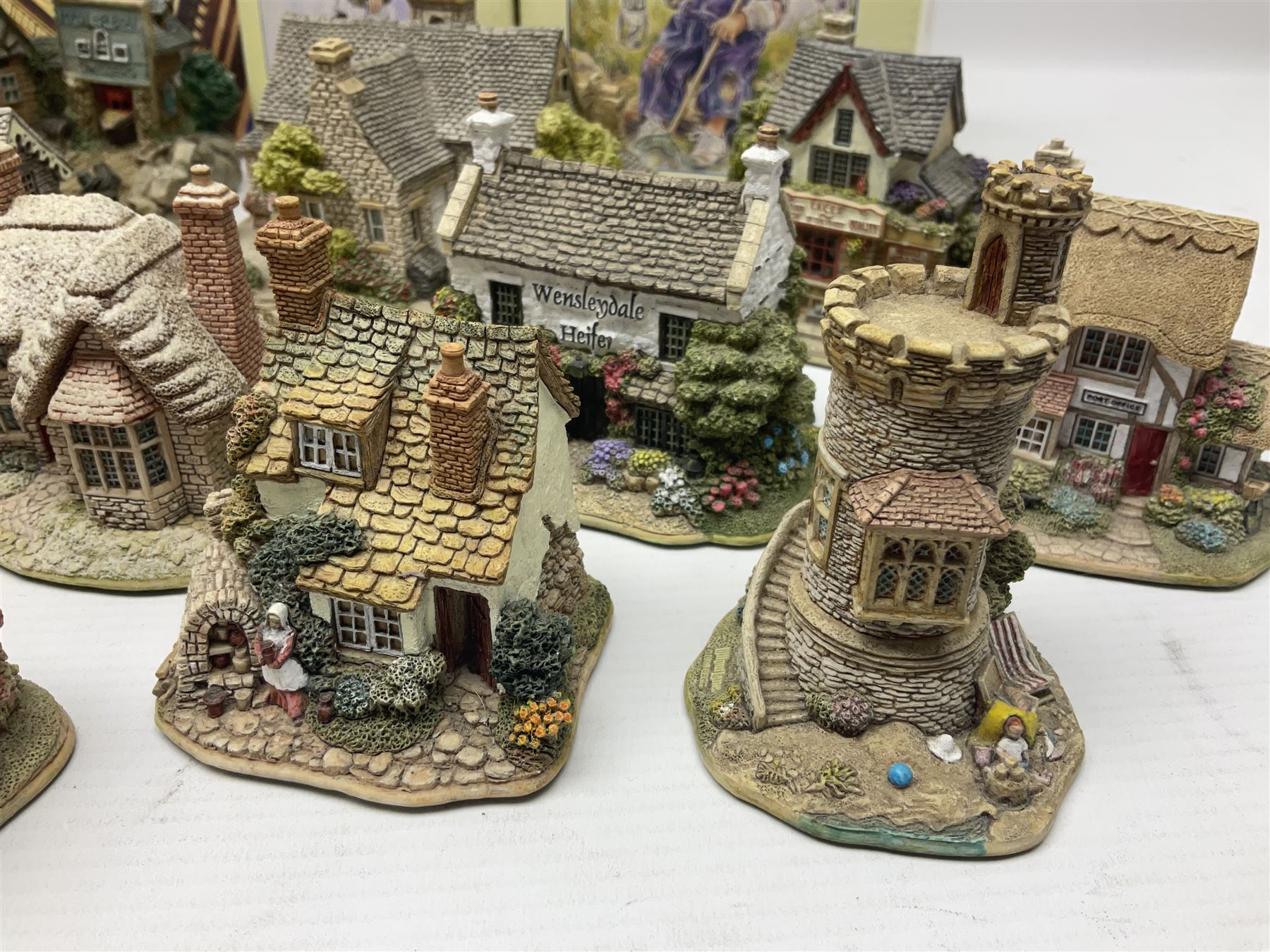 Twenty three Lilliput Lanes, including Village School, Lace's Shoe Shop, Cockles & Muscles, Scotland the Brave etc, together with The Leonardo Collection Paint Box Poppets and Gullivers World magazines 