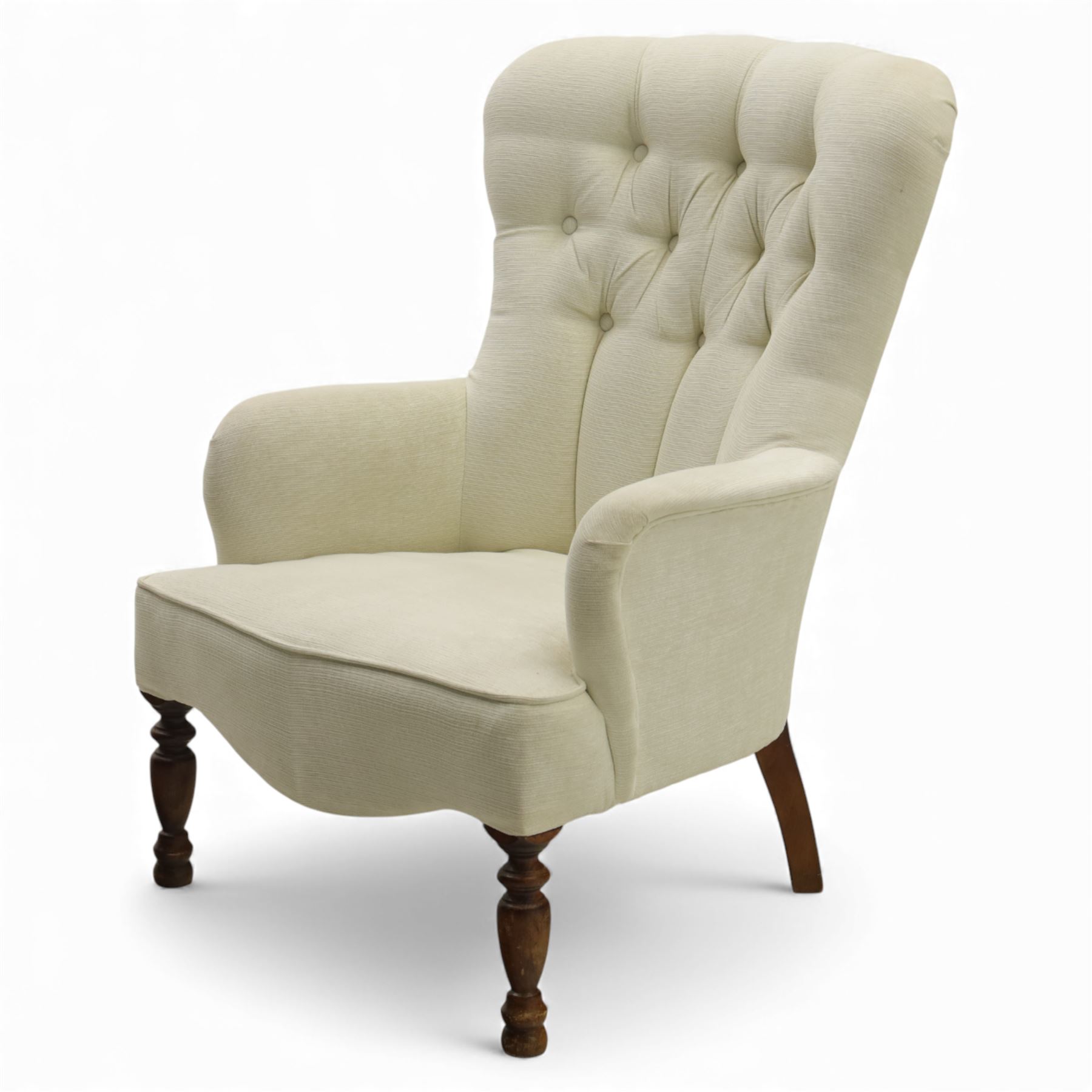 Late 20th century cream upholstered nursing chair, high button-tufted back with shaped wings, scroll arms, loose seat cushion, raised on turned front supports