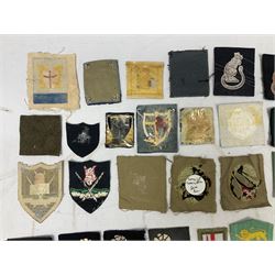 Approximately one-hundred printed and embroidered cloth badges including Royal Tank Regiment, Royal Armoured Corps, 219th Independent Infantry Brigade, Cyrenaica, Cyprus, Singapore and other districts, Gibraltar Garrison, East Anglian Brigade, 20th Armoured Brigade and various armoured divisions etc