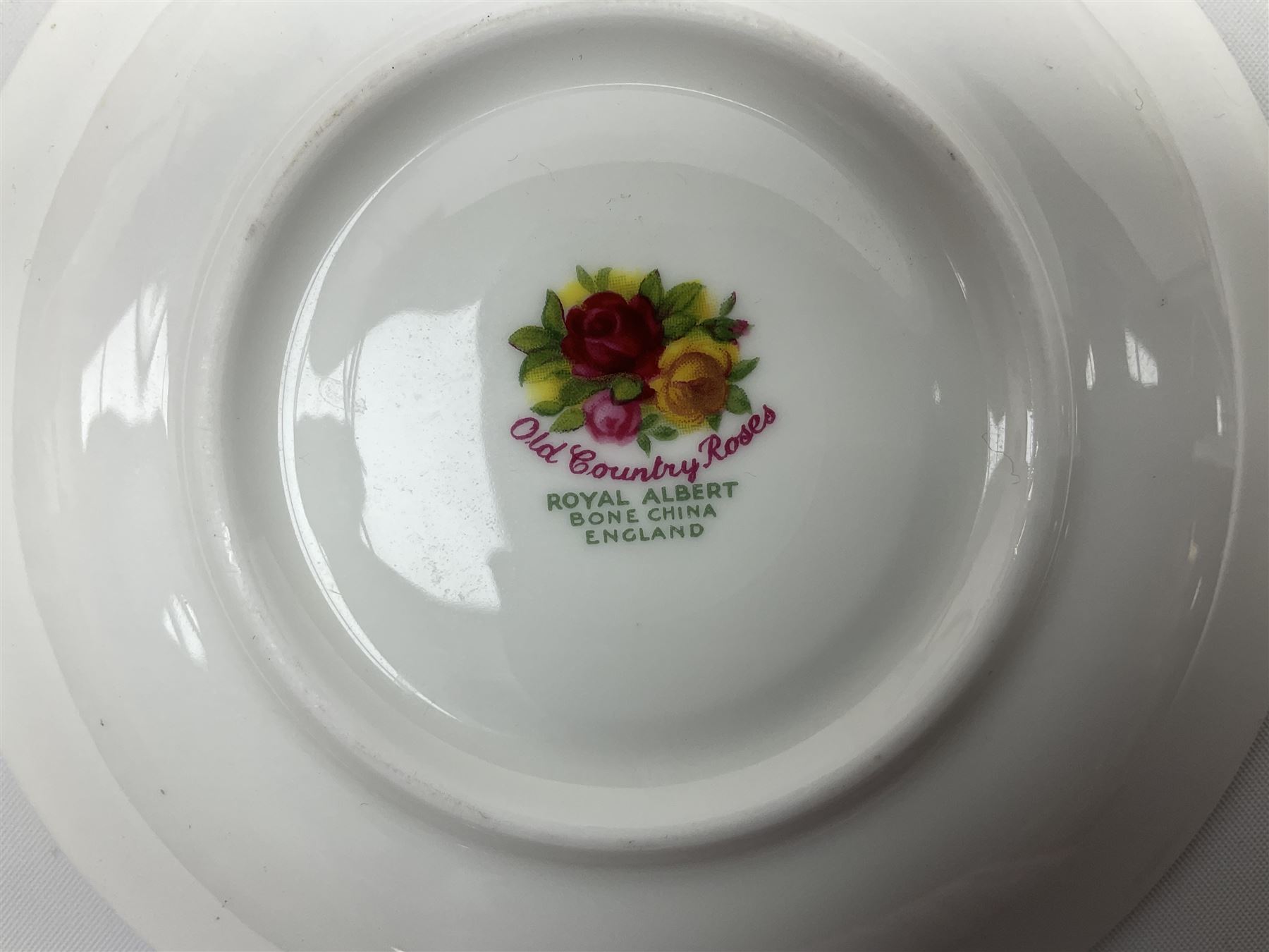 Royal Albert Old Country Roses part dinner and tea service comprising teapot, four tea cups and saucers, eight dessert plates, cake plate, cake stand, a tureen with cover, six dinner plates, an oval dish, two trinket dishes, bell and shoe decoration. 