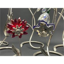 Eleven Swarovski Crystal flowers, to include violet, sunflower, delphinium, forget-me-not and lily-of-the-valley, each on stylised metal stems, tallest H23cm