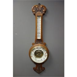  Early 20th century oak cased aneroid barometer with visible mechanism, enamel ceramic dial, mercury thermometer, 'J. Wetherell, Stockton on Tees', H86cm  