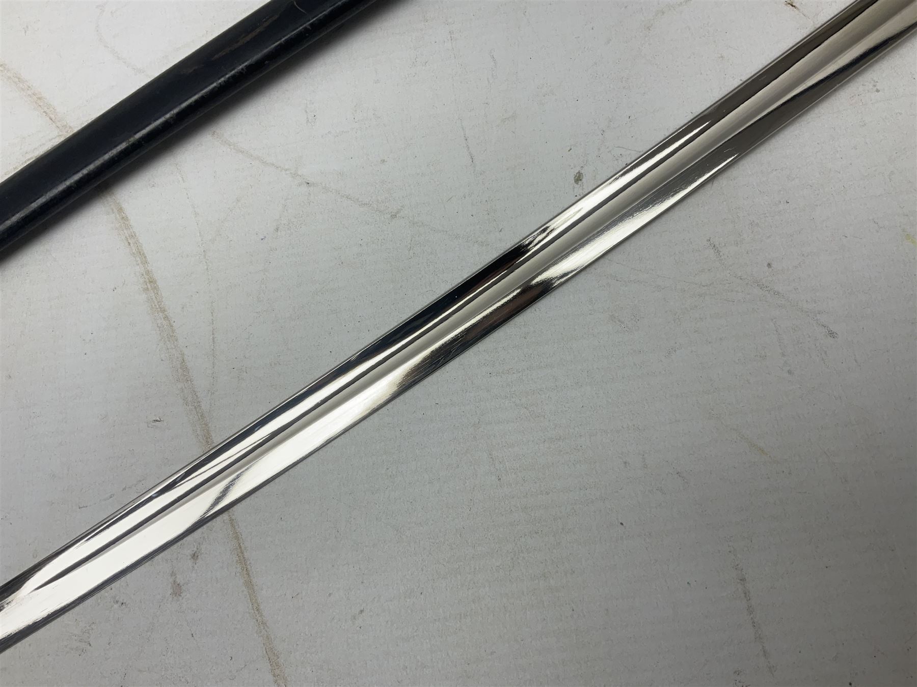 WW2 German Army Prinz Eugen Pattern Officers Dress Sword by Carl Eickhorn, the 80.5cm slightly curving fullered blade with makers name to the ricasso, gilt brass hilt with eagle to the cross-piece and relief of oakleaves to the ferrule, Prinz Eugen style down winged eagle to the pommel of the backstrap; grip retains the original wire binding; in original black painted scabbard with single hanging ring, leather hanger marked 'RZM M5/71 OLC' and silvered knot L97cm overall