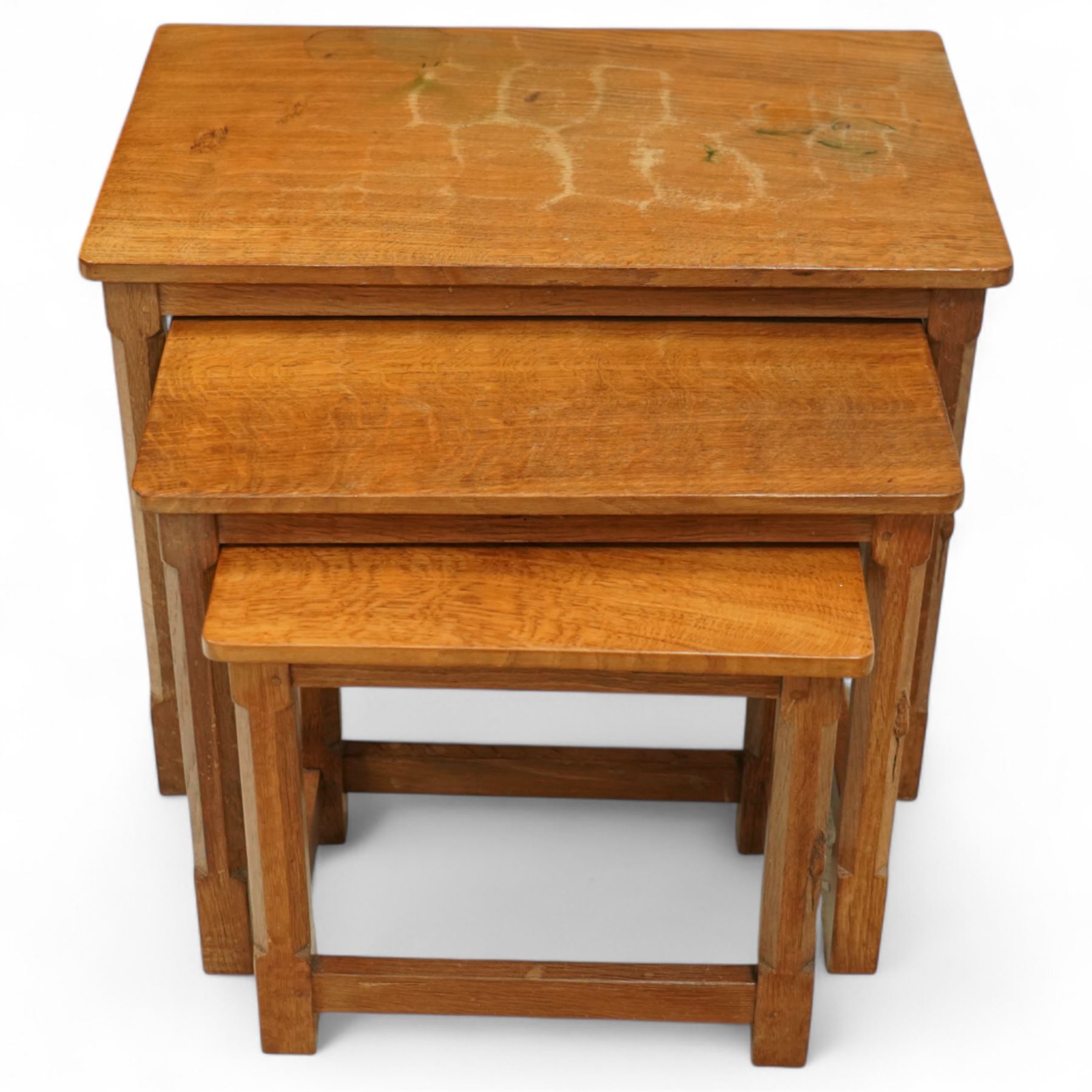 Mouseman - nest of three oak occasional tables, rectangular adzed top, on octagonal supports united by plain stretchers, each carved with mouse signature, by the workshop of Robert Thompson, Kilburn
Largest: Height: 48cm  Length/Width: 61cm  Depth/Diameter: 38cm