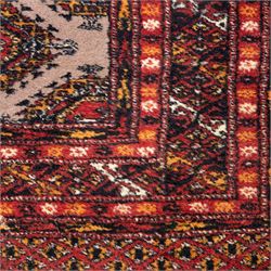 Tekke Bokhara hand knotted  runner, crimson field decorated with a series of repeating Tekke gul motifs arranged in rows within narrow geometric borders with chevron and diamond devices, 78x248cm 