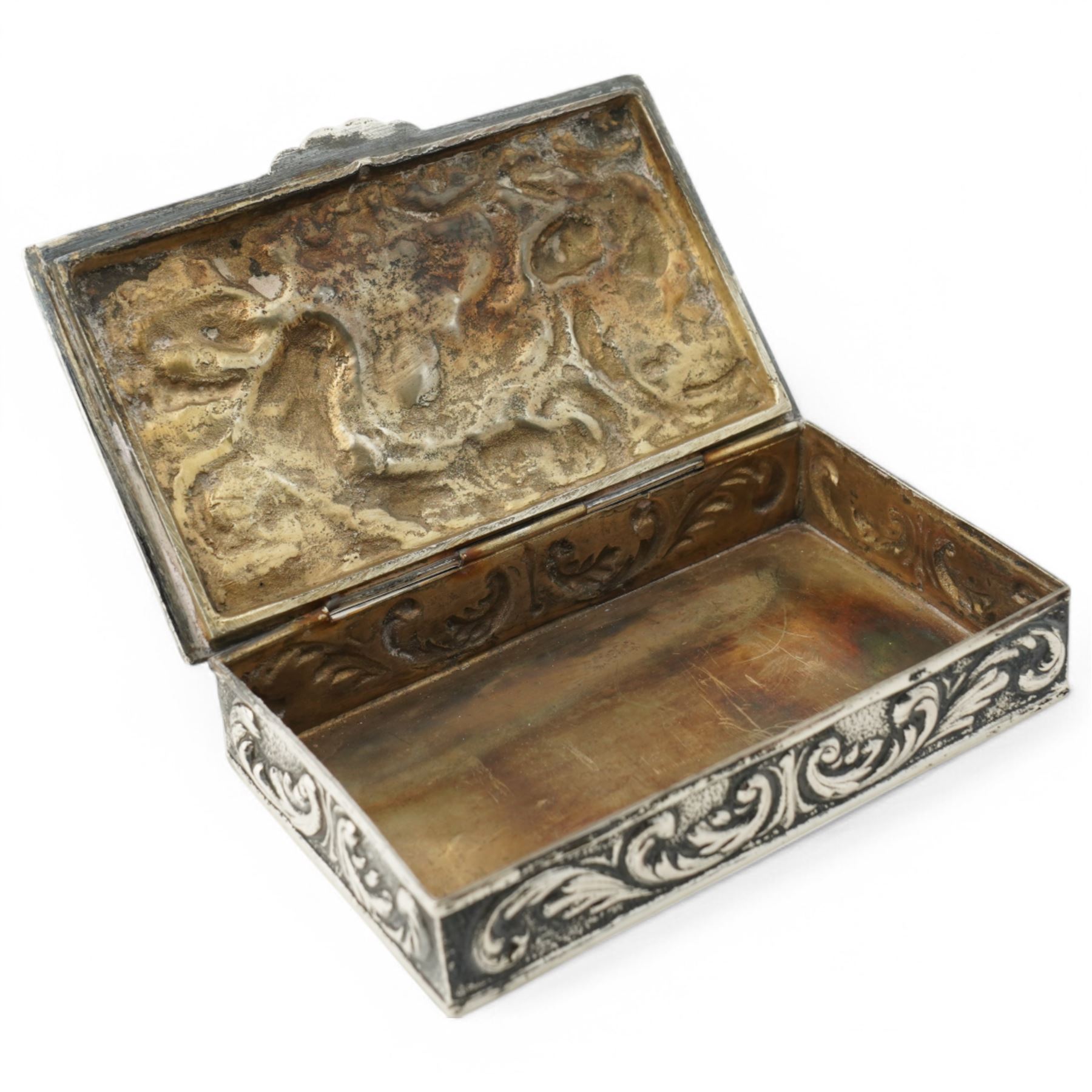 Spanish rectangular silver box, the hinged cover embossed with a hunting scene 9.5cm x 6cm 915 fineness mark and a silver decanter label 'Brandy'