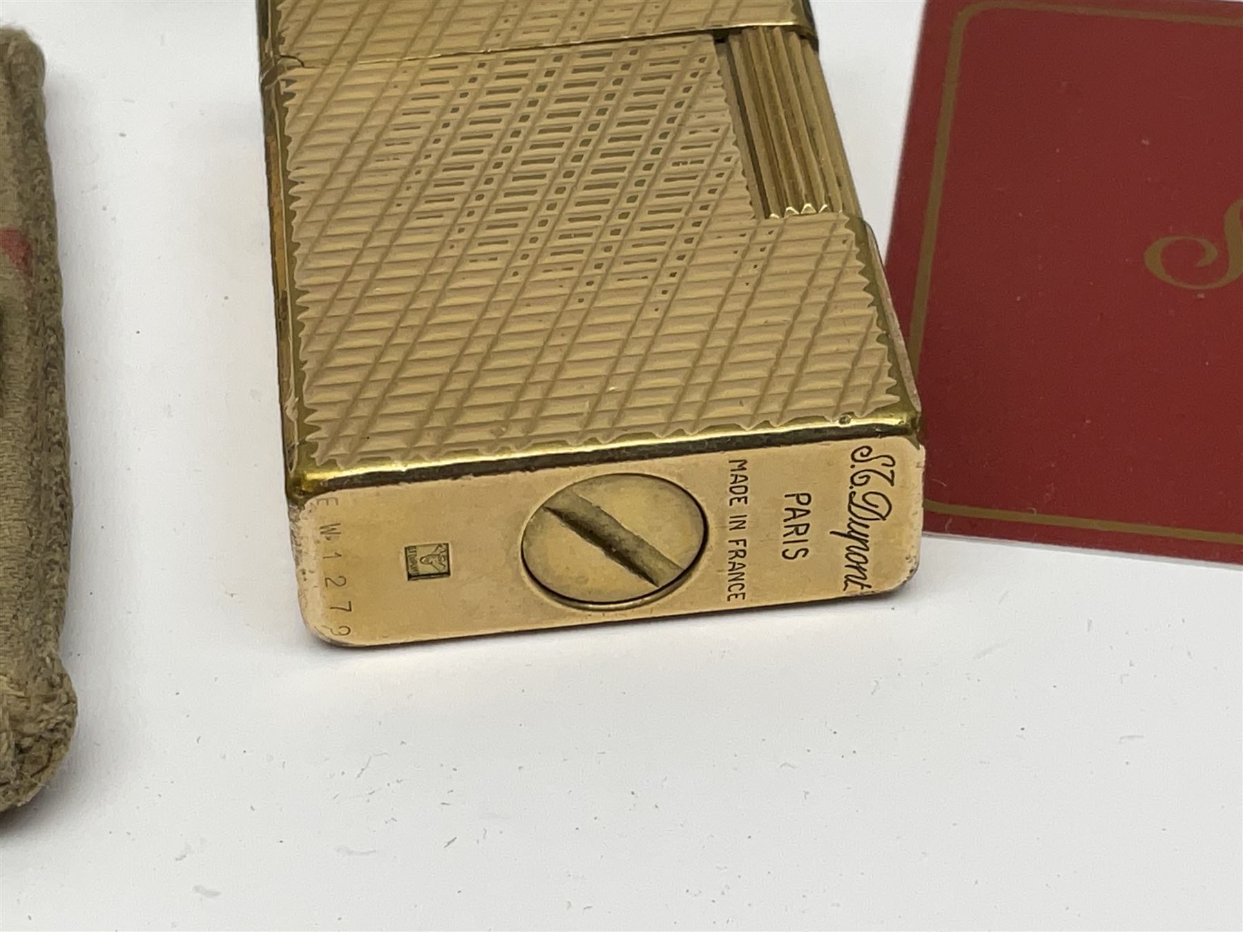 St Dupont gold plated cigarette lighter, with engine turned decoration, serial no EW1279, together with three powder compacts, including Stratton and Regent of London examples