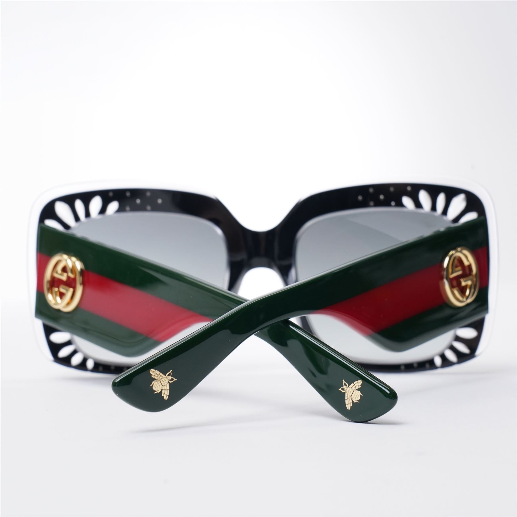 Gucci - pair of oversized black acetate sunglasses, the square frames with studded and crystal embellishment to the front and signature green and red web temples with interlocking gold-tone GG logo and bee motif, unused with original velvet pouch and box