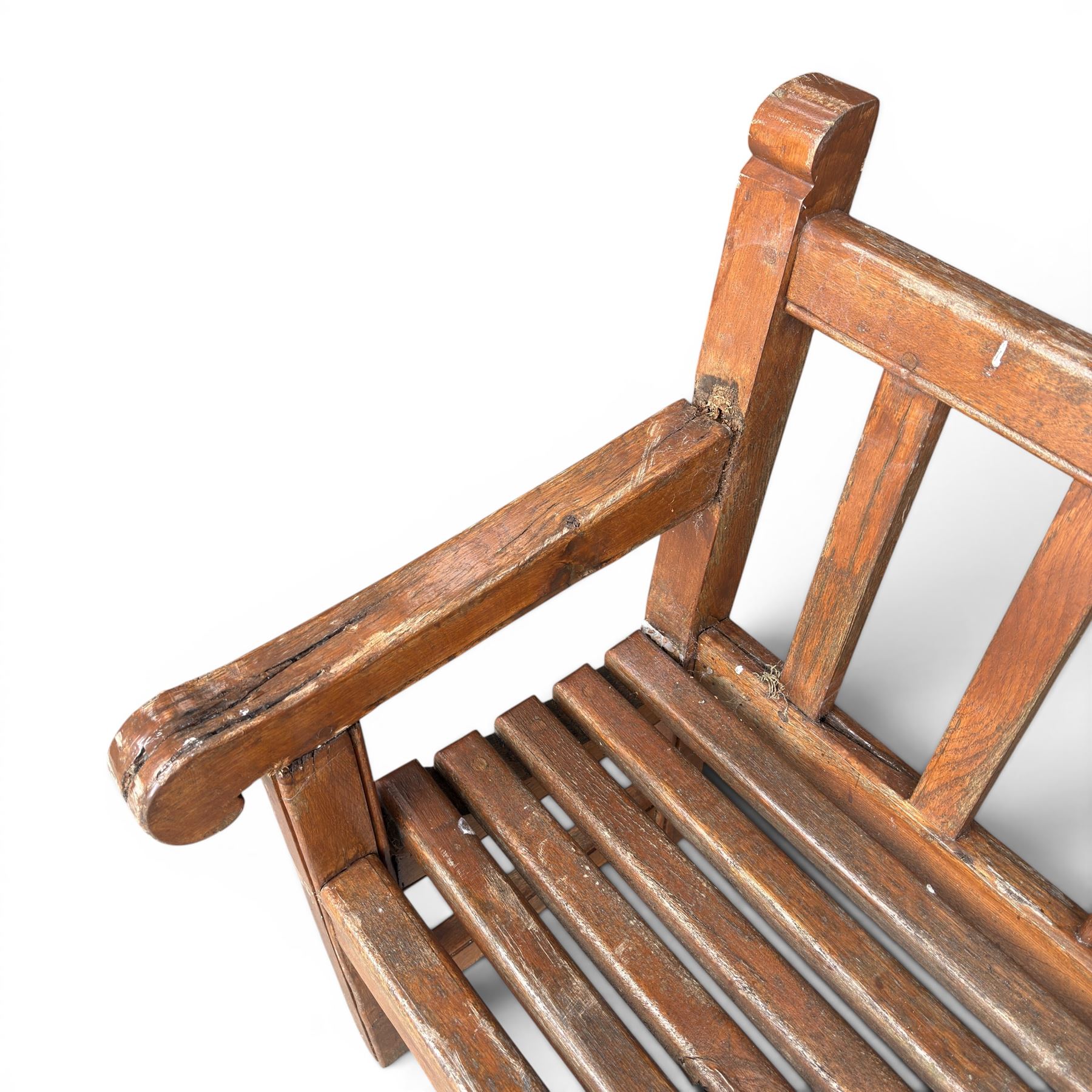 20th century teak cricket bench featuring a central splat with moulded cricket bat and ball motif flanked by stylised wicket spindles, over a slatted seat and square supports