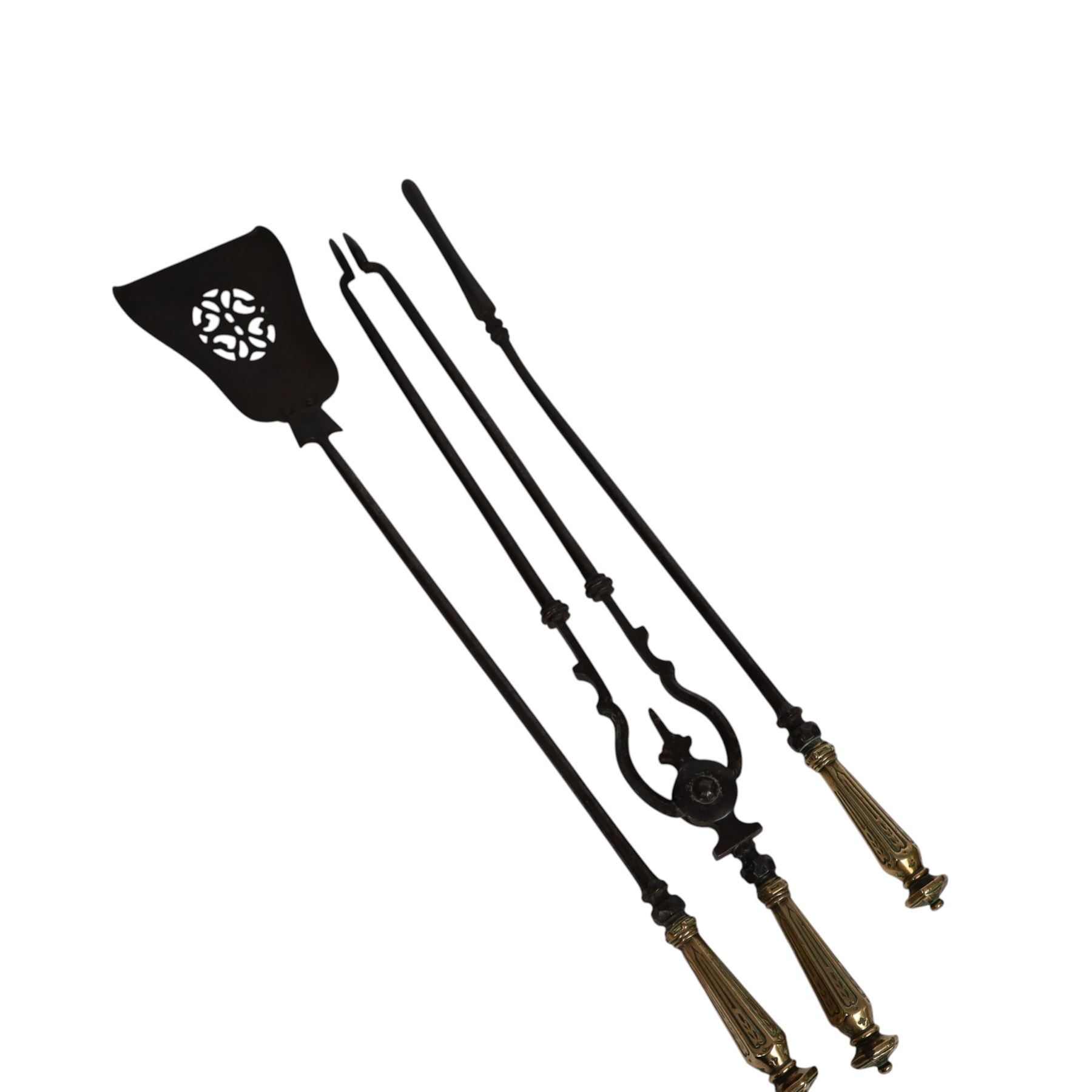 Set of three 19th century brass and steel fire irons, each with tapering and hexagonal capped handles, comprising poker, tongs and shovel with pierced detail, poker L84cm