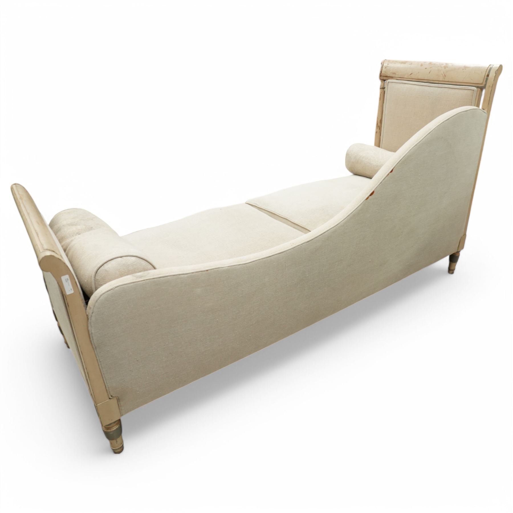 19th Century French day bed, the shaped back and scroll ends with fluted supports and carved rosettes, upholstered in natural linen with loose seat cushions and bolster pillows