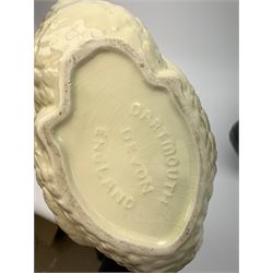 Four Dartmouth pottery jardinières or planters, modelled in the form of swans, comprising three white examples, and one black, marked beneath Dartmouth Devon England, larger examples H29cm, smaller examples H21.5cm. 