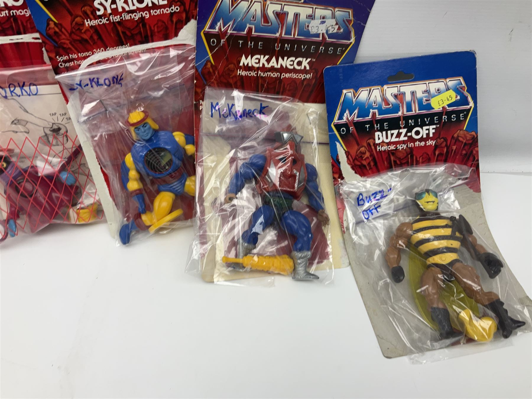 Thirty-one Masters of the Universe He-Man figures re-bagged on original backing cards;  two others lacking backing cards; boxed Modulok figure; bag of weapons and accessories; Roton, two horses and two battle cats; 1986 & 1987 Annuals; Ladybird and other story books; Panini sticker album; instructions etc
