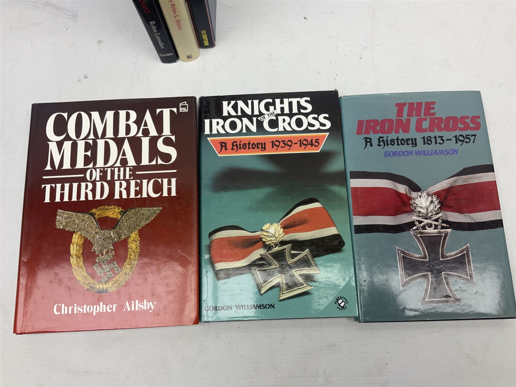 Ten books of German medal interest including Robin Lumsden: Medals and Decorations of Hitler's Germany; Forman's Guide to Third Reich German Awards ... and Their Values. Signed by the author; Christopher Ailsby: Combat Medals of The Third Reich; Gordon Williamson: The Iron Cross A History 1813-1957 and Knights of the Iron Cross A History 1939-1945; and five others (10)