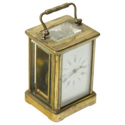 Two early 20th century 8-day French Carriage clocks- one with its original traveling case, lever platform escapement, enamel dial and Roman numerals, the other with a cylinder platform escapement, enamel dial with Roman numerals and five minute Arabic's.  